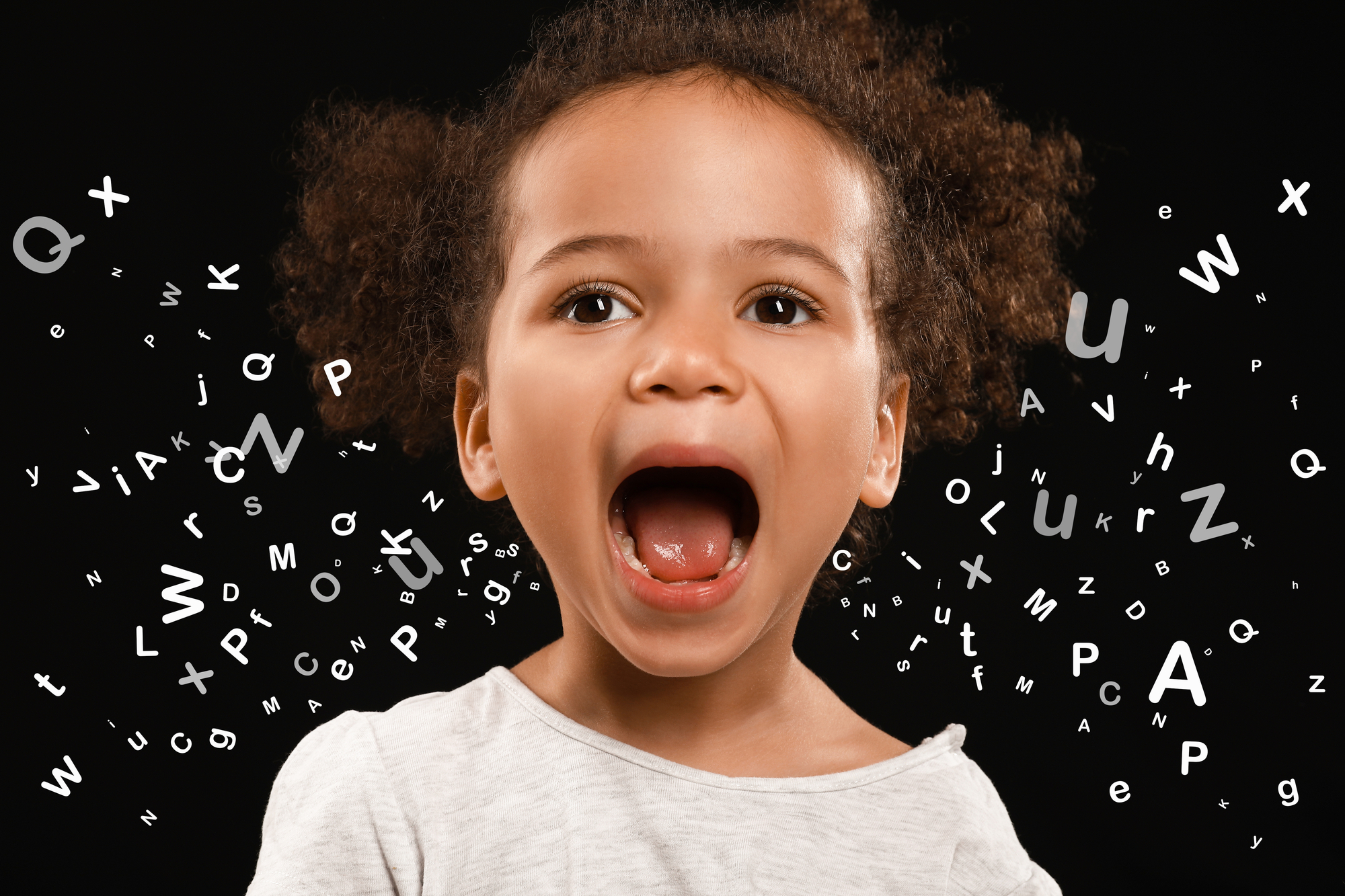 Young child with letters emanating to represent language and expression