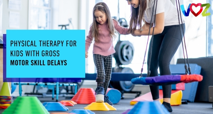 Young girl practicing balance and coordination on colorful stepping stones with assistance from a pediatric physical therapist during a gross motor skills therapy session. | The Voz Institute | Pediatric Physical Therapists in Washington DC